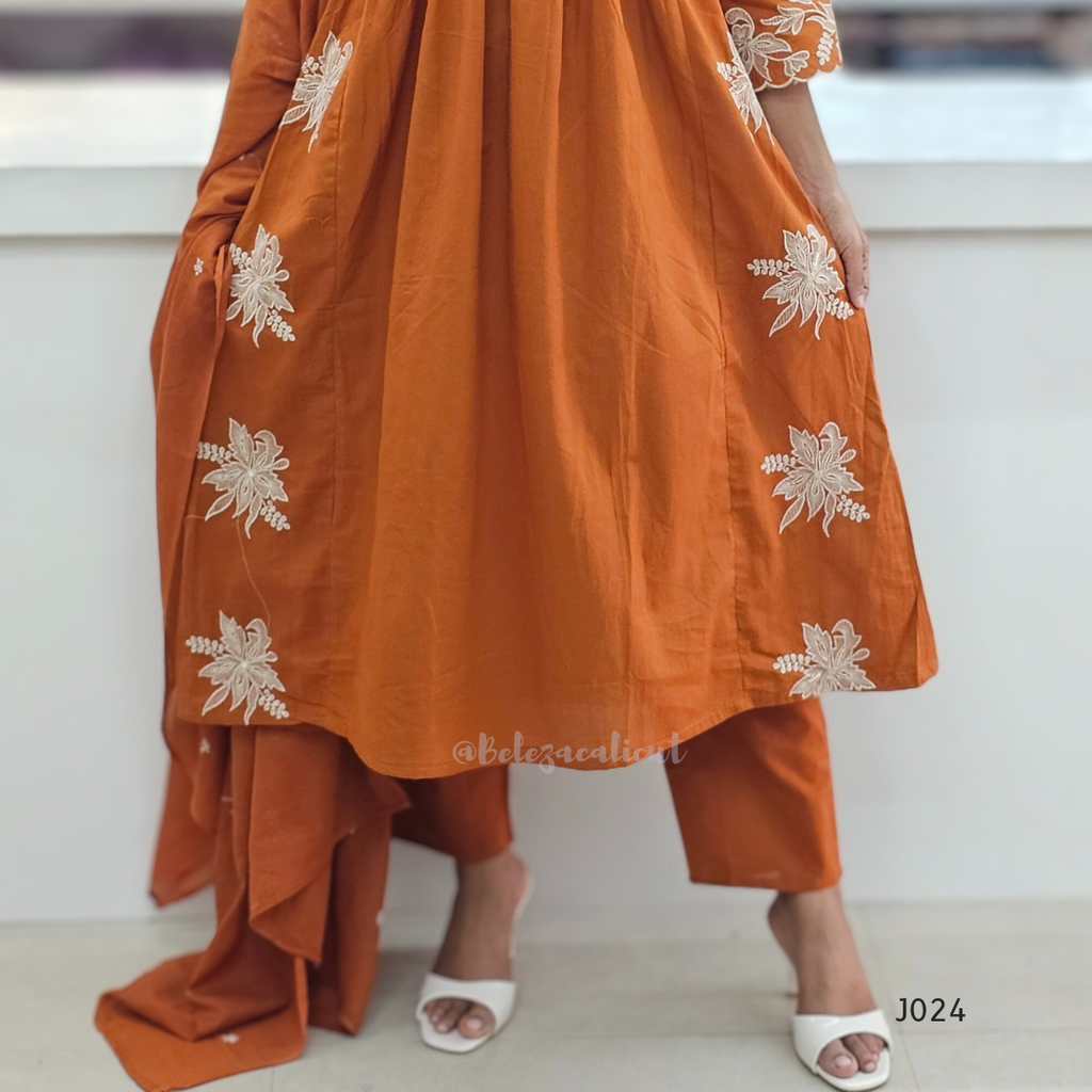 Orange traditional outfit with white floral embroidery on a white background