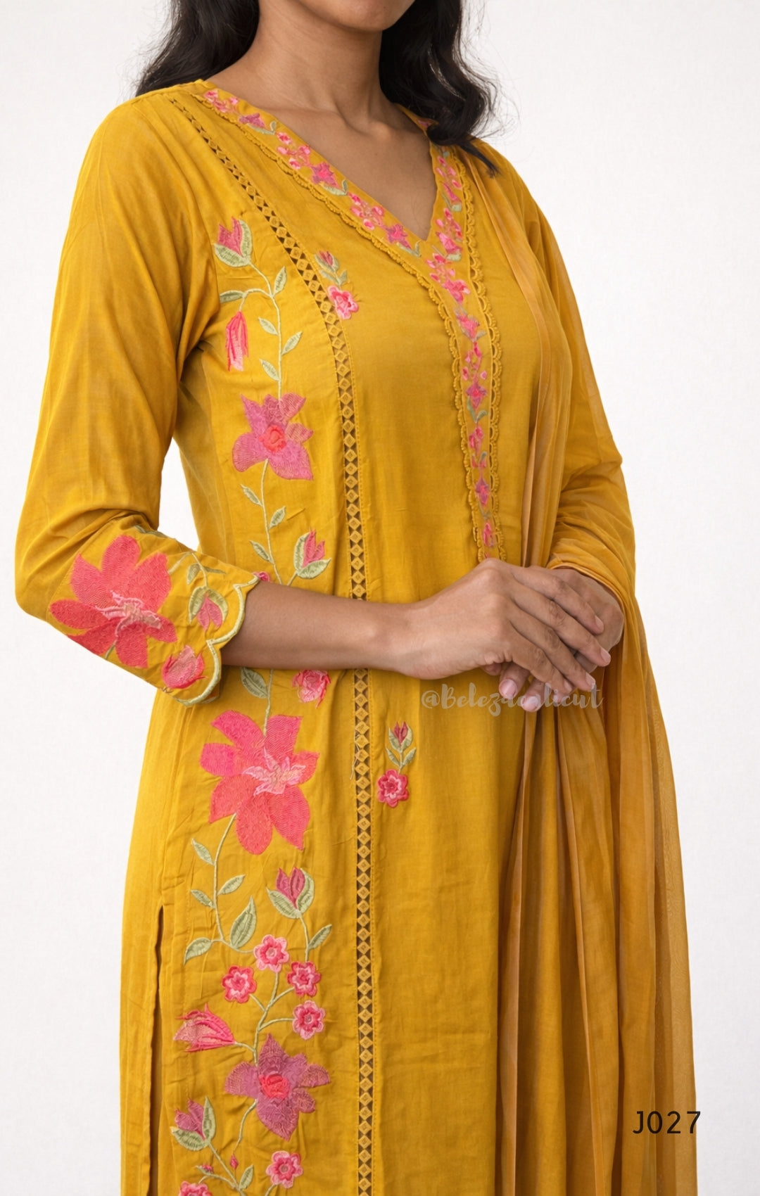 Yellow kurta with pink floral embroidery on a white background