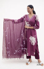 Woman wearing a purple traditional outfit with white floral patterns on a white background