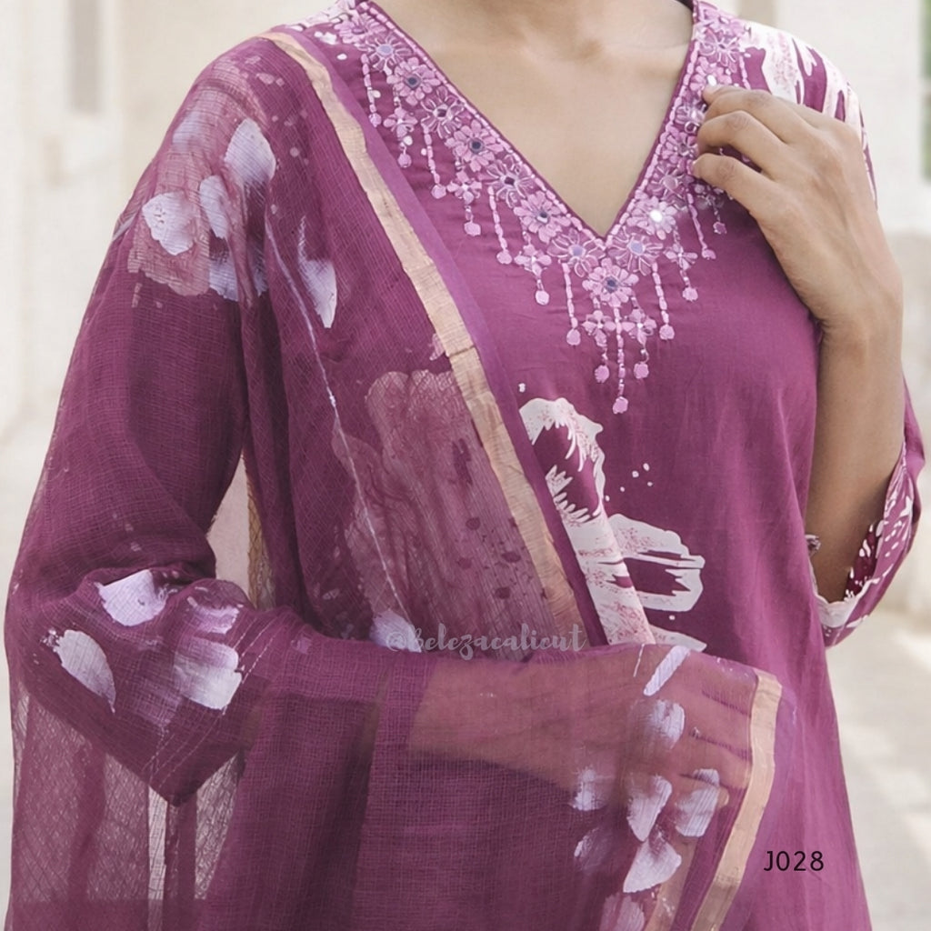 Purple traditional outfit with floral patterns and embellishments on a neutral background