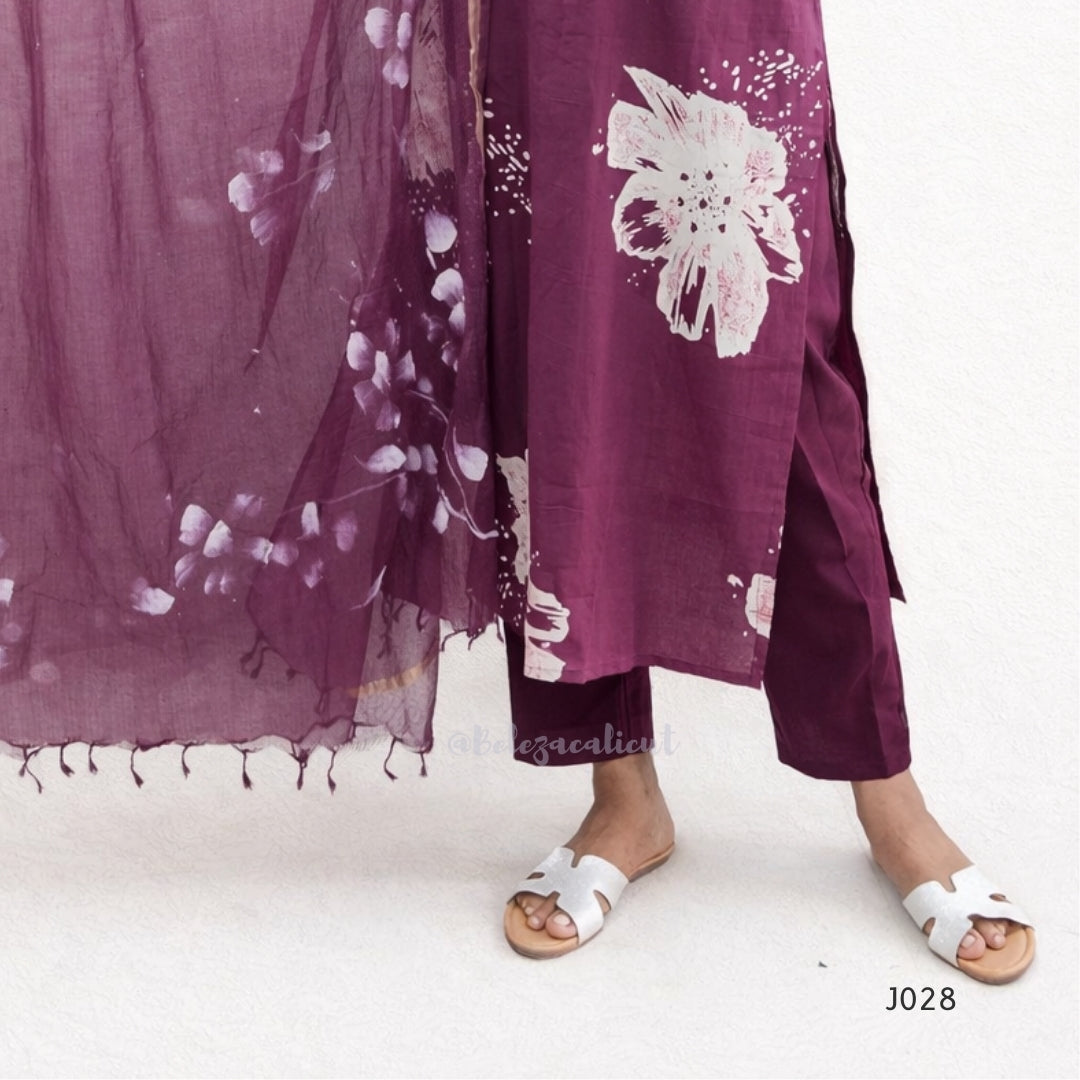 Purple floral scarf and pants with white sandals on a white background