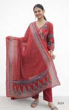 Woman wearing a red traditional outfit with a patterned dupatta on a white background