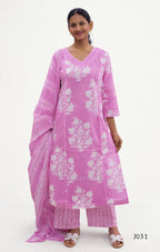 Woman wearing a pink traditional outfit with white floral patterns on a white background