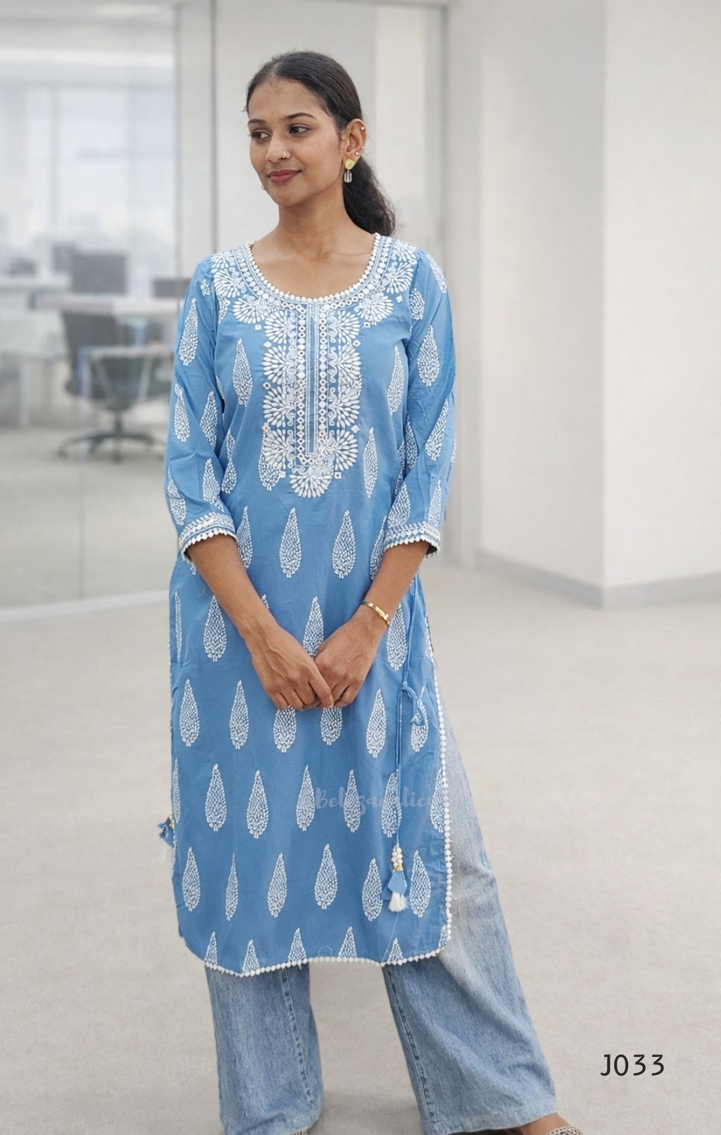 Woman wearing a blue and white patterned kurta in an office setting