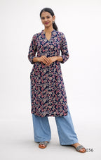 Woman wearing a floral kurta with blue pants on a white background