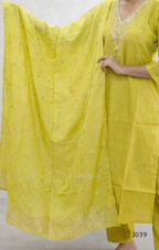 Yellow traditional outfit with intricate patterns on a plain background