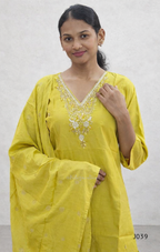 Woman wearing a yellow traditional outfit with intricate designs on a white background