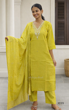 Woman wearing a yellow traditional outfit with a matching dupatta indoors.