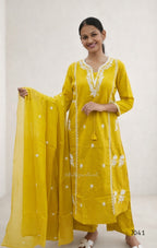 Woman wearing a yellow traditional outfit with white embroidery on a white background