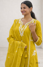 Woman wearing a yellow embroidered kurta against a white background