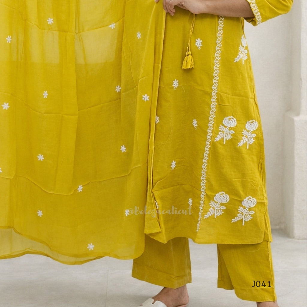 Yellow embroidered traditional outfit on a white background