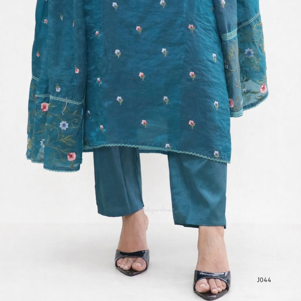 Teal embroidered outfit with matching pants on a white background
