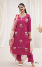 Woman wearing a pink embroidered outfit with a white background
