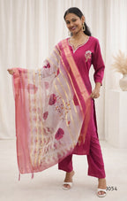 Woman wearing a pink traditional outfit with a matching dupatta against a white background