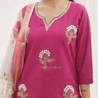 Pink traditional outfit with floral embroidery on a plain background