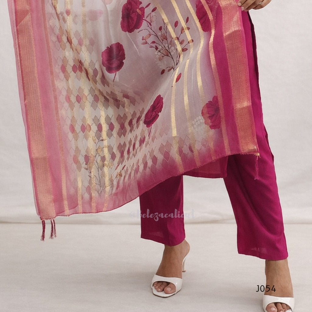 Woman wearing a pink floral dupatta and pants on a white background