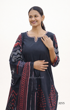 Woman wearing a black dress with red and white patterns on a white background