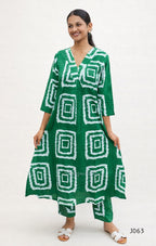 Woman wearing a green dress with white geometric patterns on a white background