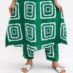 Green patterned skirt with white geometric designs on a white background