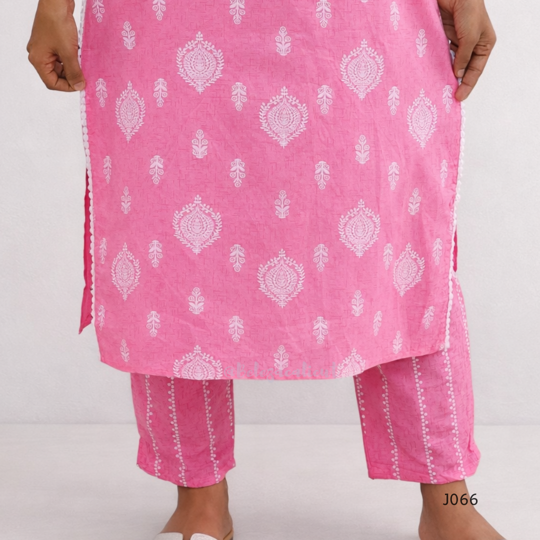 Pink traditional outfit with white patterns on a plain background