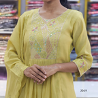Yellow embroidered dress worn by a person in a store setting