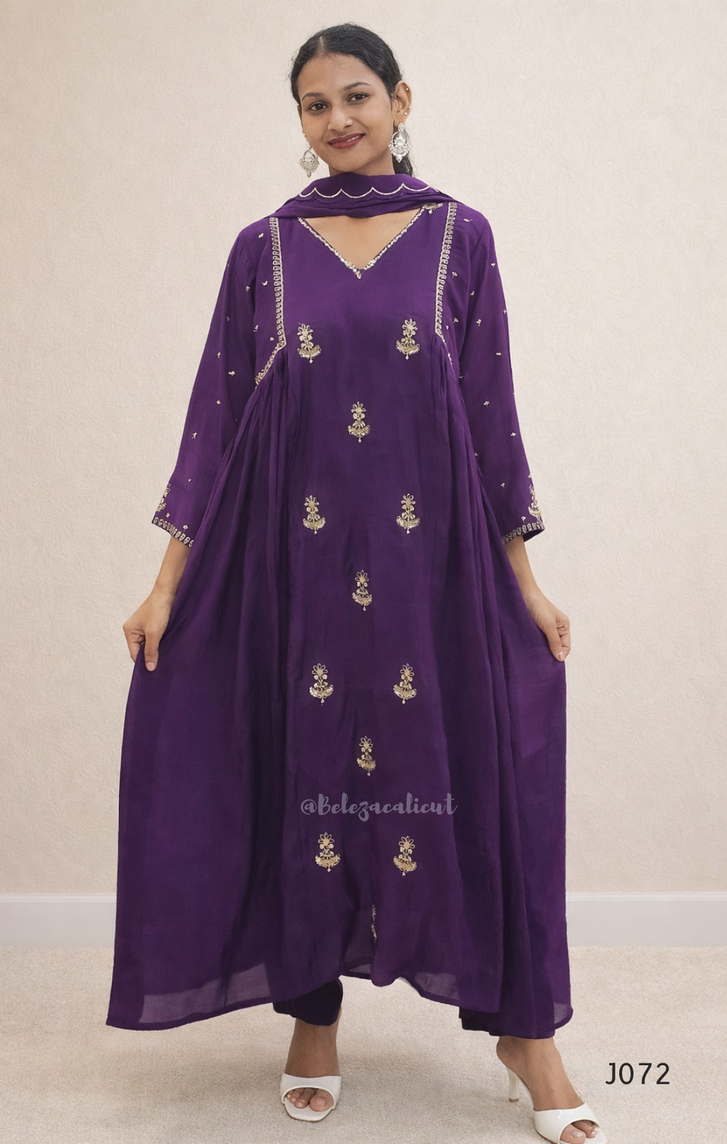 Woman wearing a purple embroidered outfit