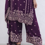 Purple traditional outfit with intricate white embroidery on a white background