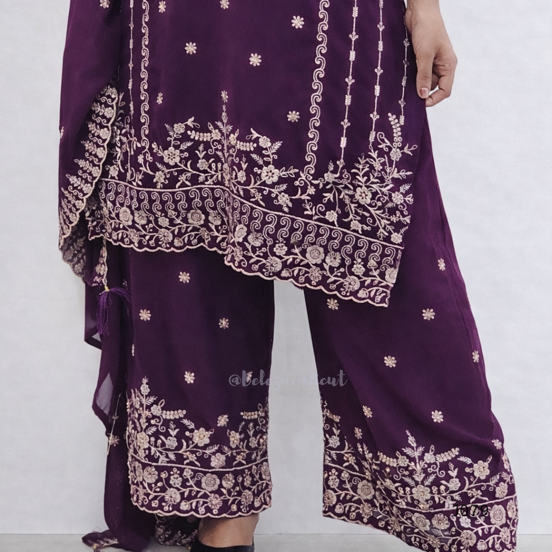 Purple traditional outfit with intricate white embroidery on a white background