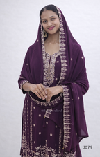 Woman wearing a purple embroidered traditional outfit on a white background
