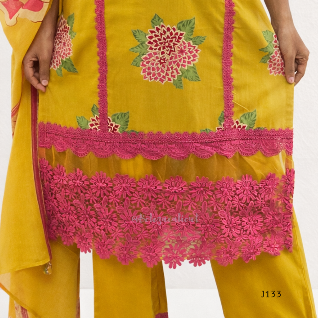 Yellow outfit with pink floral embroidery on a white background