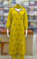 Yellow embroidered outfit on a mannequin with a blurred store background
