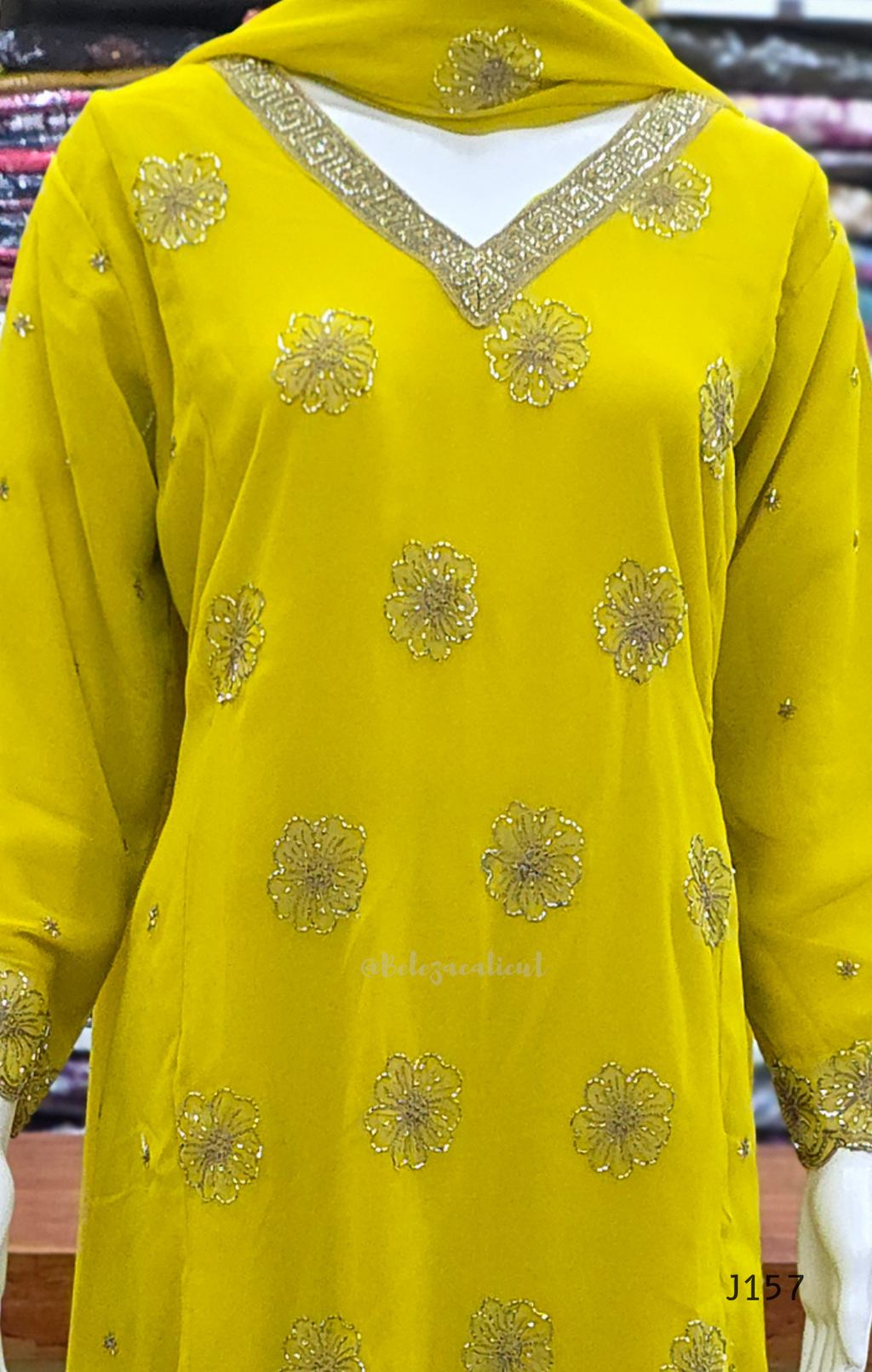 Yellow embroidered garment with gold details on a blurred background