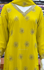 Yellow embroidered garment with gold details on a blurred background