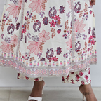 Floral and paisley patterned fabric with a person wearing it.