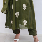 Green outfit with white floral patterns on a plain background