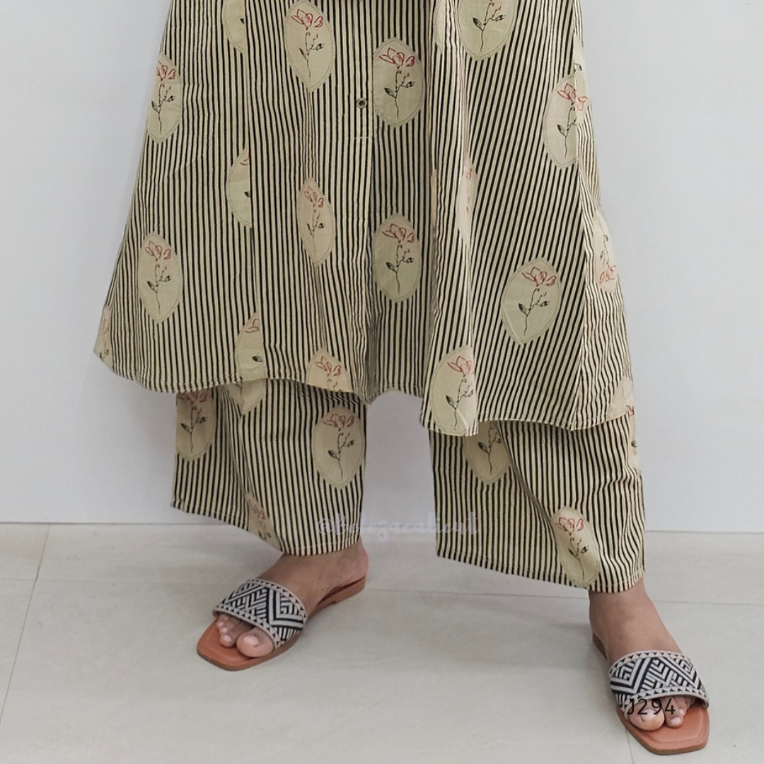 Person wearing a layered outfit with floral and striped patterns on a white background