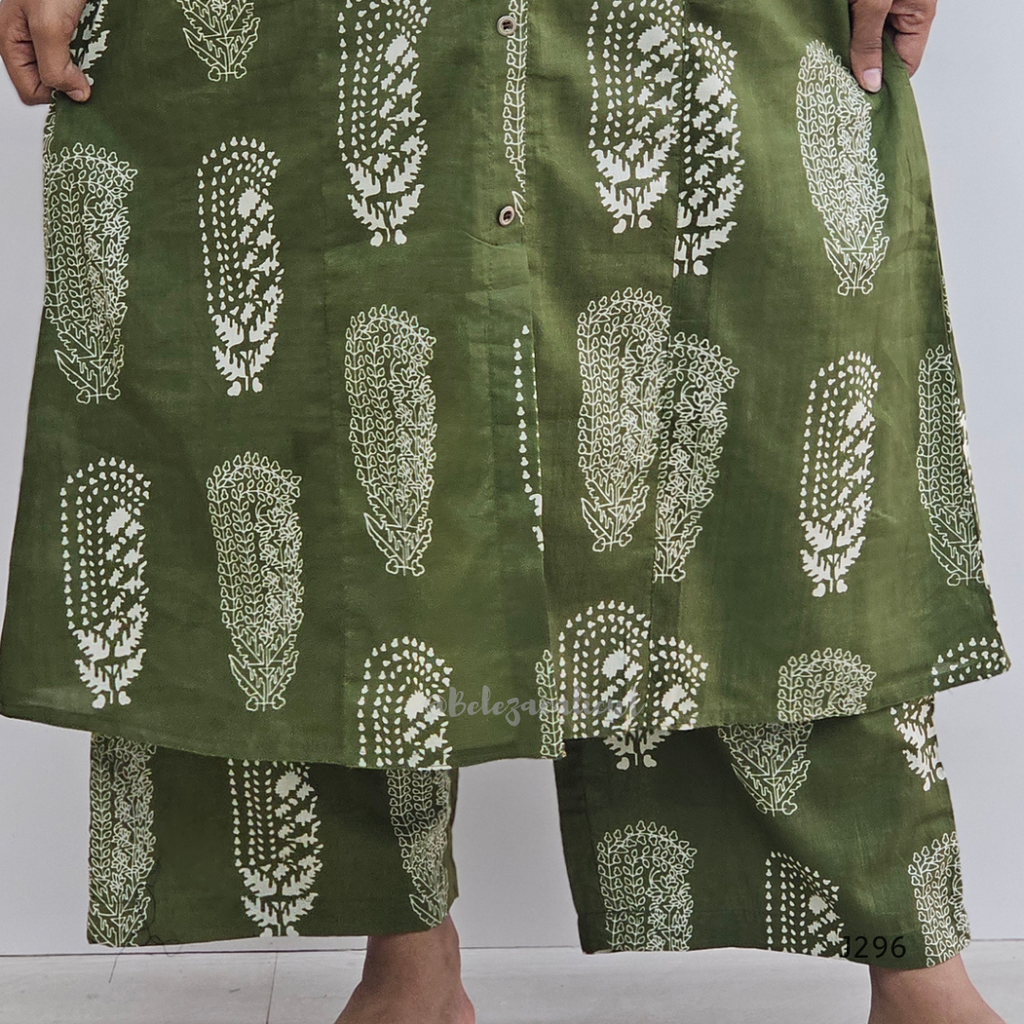 Green skirt with white pattern worn by a person on a plain background