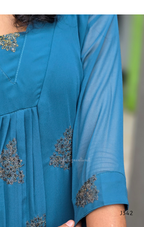 Blue dress with floral embroidery on a blurred background