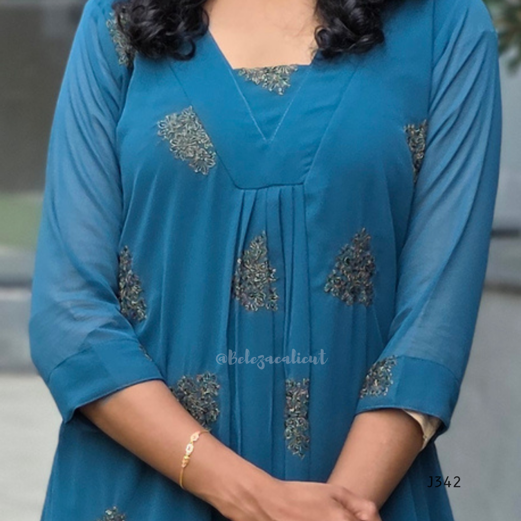 Blue dress with intricate patterns on a blurred background