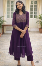 Woman wearing a purple outfit with a patterned top in an indoor setting.