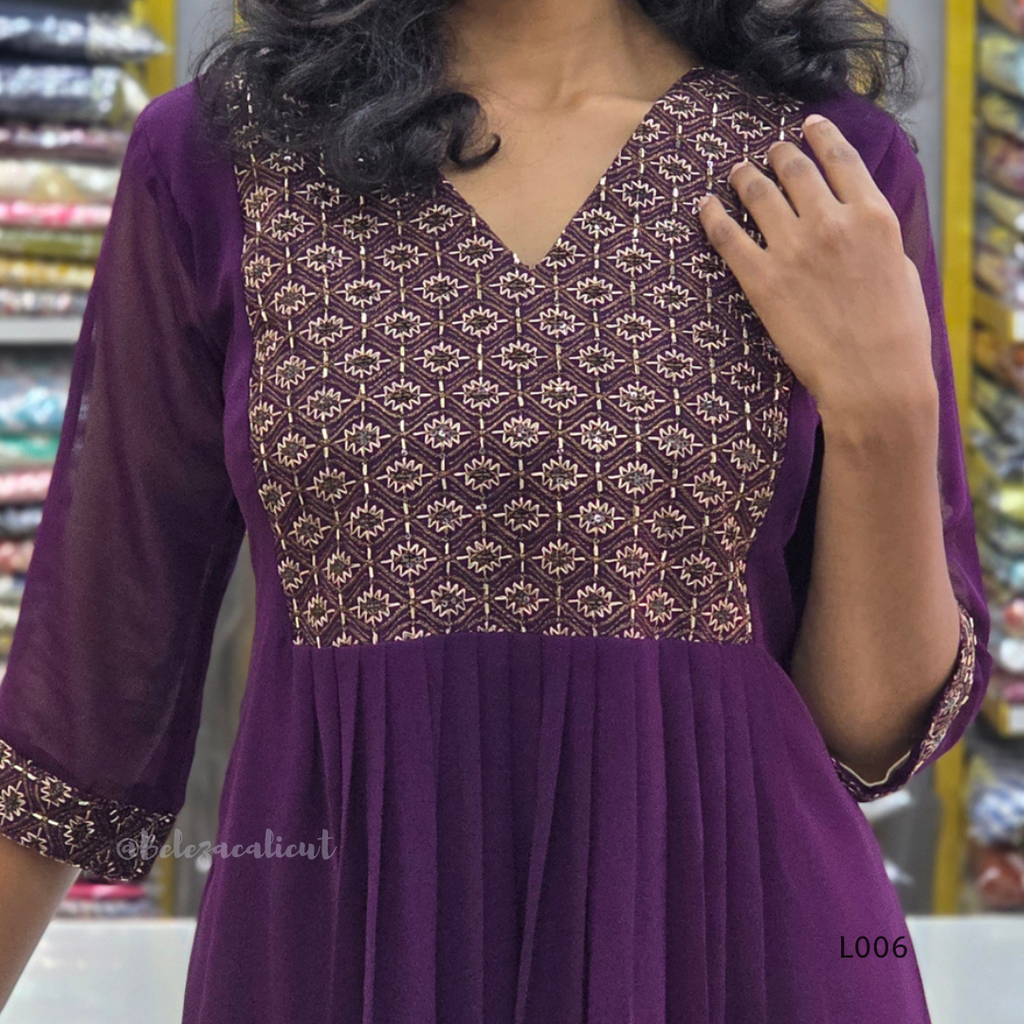 Purple dress with intricate patterned top in a store setting