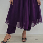 Purple layered outfit with high-waisted pants and a flowing top on a plain background.