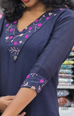 Navy blue kurta with floral embroidery on a blurred background