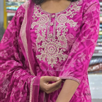 Close-up of a pink embroidered traditional outfit with intricate patterns.