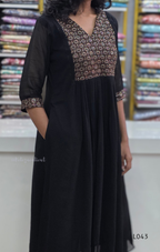 Black dress with patterned top in a fabric store