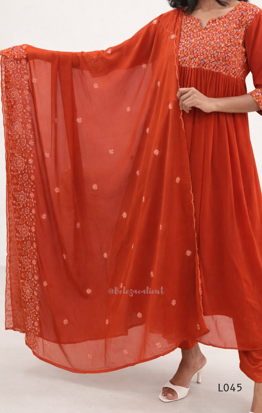 Red traditional outfit with a matching dupatta on a white background