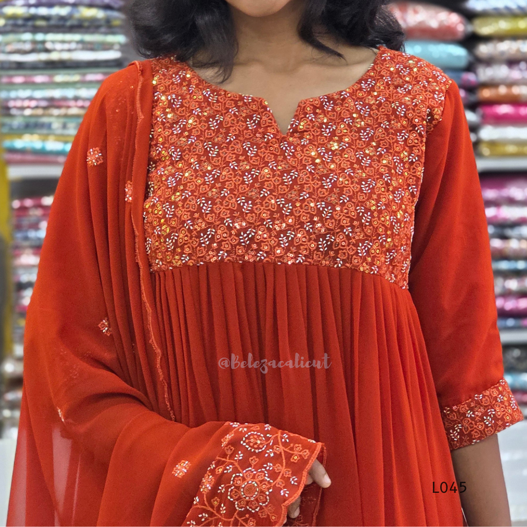 Red traditional outfit with floral patterns in a store setting
