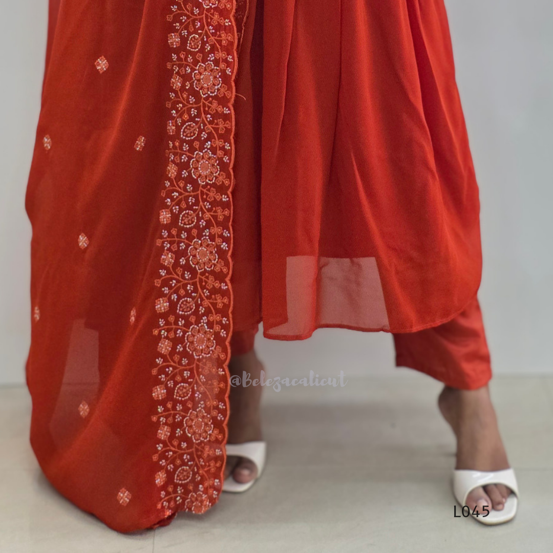 Red traditional outfit with floral embroidery on a plain background