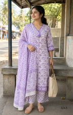 Soft cream and lavender cotton churidar set with floral print, dupatta and mirror-style neckline. Available at Beleza Calicut.