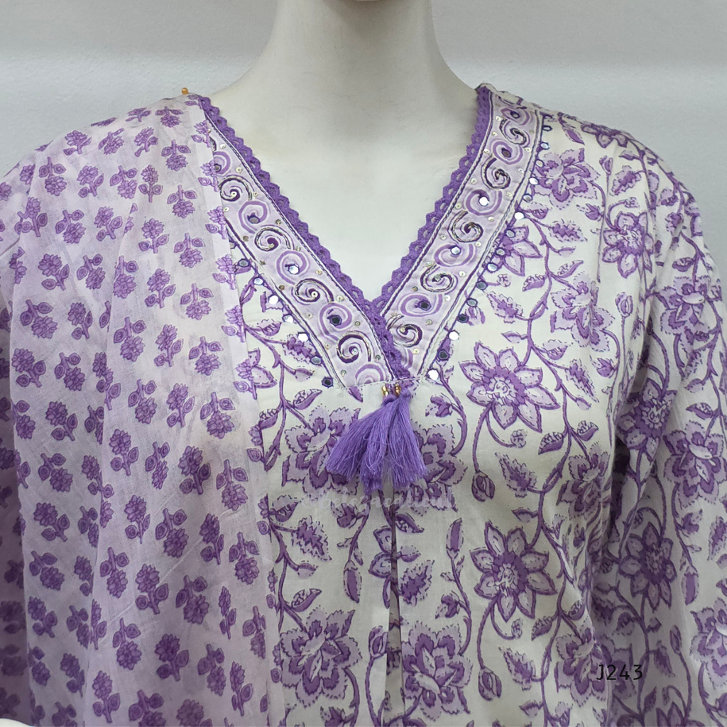 Soft cream and lavender cotton churidar set with floral print, dupatta and mirror-style neckline. Available at Beleza Calicut.